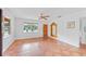 Bright living room featuring terracotta tile floors and a large mirror at 1841 Buccaneer Dr, Sarasota, FL 34231