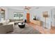 Living room features a sectional sofa, coffee table, and terracotta tile floors at 1841 Buccaneer Dr, Sarasota, FL 34231
