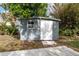 Gray shed in the backyard with white door at 1841 Buccaneer Dr, Sarasota, FL 34231