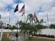Community entrance with flags and landscaping at 808 53Rd E Ave # 8, Bradenton, FL 34203