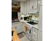 Bright white kitchen with stainless steel appliances and decorative accents at 808 53Rd E Ave # 8, Bradenton, FL 34203