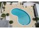 Aerial view of kidney-shaped community pool with surrounding lounge chairs at 808 53Rd E Ave # 8, Bradenton, FL 34203