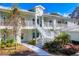 Two-story light green building with white railings and stairs, landscaping, and a walkway at 294 Hidden Bay Dr # 103, Osprey, FL 34229
