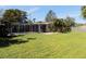 This charming home boasts a spacious backyard with a screened pool, perfect for outdoor living at 6555 Connecticut Ave, Sarasota, FL 34243