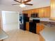 Kitchen boasting oak cabinets, black appliances, and a neutral countertop at 6555 Connecticut Ave, Sarasota, FL 34243