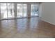 Living room boasting neutral tile, sliding glass doors, and lots of natural light at 6555 Connecticut Ave, Sarasota, FL 34243