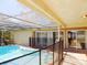 Outdoor covered pool area with a pool safety fence at 6555 Connecticut Ave, Sarasota, FL 34243