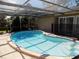 Screened-in pool with clear blue water and ample sunlight, steps leading into the pool at 6555 Connecticut Ave, Sarasota, FL 34243