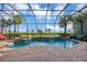 Screened pool and spa with a waterfall feature at 1259 Tyne Ln, Bradenton, FL 34208