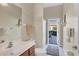 Bright bathroom with a walk-in shower, a vanity, and access to the outdoor patio at 2921 Seasons Blvd, Sarasota, FL 34240