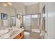 Bathroom featuring a vanity, a toilet, and a shower-tub combo with glass doors at 2921 Seasons Blvd, Sarasota, FL 34240