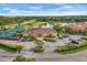 Overview of a community center featuring manicured landscaping, parking, and amenities at 2921 Seasons Blvd, Sarasota, FL 34240