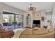 Spacious living room with hardwood floors, a ceiling fan, and sliding glass doors leading to the screened lanai at 2921 Seasons Blvd, Sarasota, FL 34240