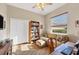Inviting living room with a cozy couch, a bookshelf, and a sunlit window at 2921 Seasons Blvd, Sarasota, FL 34240