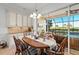 Charming dining room with wooden table and view of the pool at 5130 Tidewater Preserve Blvd, Bradenton, FL 34208