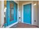 Modern front entry featuring double blue doors and a welcome sign at 5130 Tidewater Preserve Blvd, Bradenton, FL 34208
