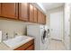 Laundry room with washer, dryer, cabinets and a utility sink at 5130 Tidewater Preserve Blvd, Bradenton, FL 34208