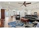 Open living space with comfortable seating, a large TV, and a view to the kitchen at 5130 Tidewater Preserve Blvd, Bradenton, FL 34208
