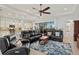 Open concept living area with leather furniture, a large rug, and kitchen views at 5130 Tidewater Preserve Blvd, Bradenton, FL 34208