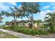 Single-story home with tile roof, landscaped yard, and stone accents at 1109 The Rialto, Venice, FL 34285