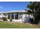 View of home's back, showcasing a Florida room and lawn at 4105 33Rd Avenue W Dr # 4105, Bradenton, FL 34205