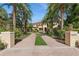 Grand two-story home with palm trees and brick driveway at 9452 Swaying Branch Rd, Sarasota, FL 34241