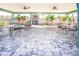 Covered patio with tables and chairs, and grilling area at 1055 Beach Rd # B-302, Sarasota, FL 34242