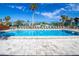 Refreshing community pool with surrounding lounge chairs and patio umbrellas at 1055 Beach Rd # B-302, Sarasota, FL 34242