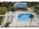 Aerial view of resort-style pool with lounge chairs and a covered patio at 1055 Beach Rd # B-302, Sarasota, FL 34242