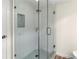 Modern shower with glass enclosure, mosaic tile, and updated fixtures at 1055 Beach Rd # B-302, Sarasota, FL 34242