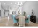 Open concept dining area with a dark wood table and four light teal chairs at 7187 Boca Grove Pl # 202, Lakewood Ranch, FL 34202