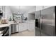 Modern kitchen with stainless steel appliances and white cabinets at 7187 Boca Grove Pl # 202, Lakewood Ranch, FL 34202