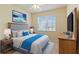 Comfortable bedroom with a gray headboard and wood dresser at 115 Winding River Trl, Bradenton, FL 34212