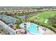 Community pool and tennis courts with surrounding landscape at 115 Winding River Trl, Bradenton, FL 34212