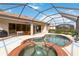 Kidney-shaped pool and spa with brick coping and screened enclosure at 115 Winding River Trl, Bradenton, FL 34212