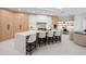 Modern kitchen with large island, marble countertops and built-in desk area at 1808 Flower Dr, Sarasota, FL 34239