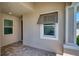 Covered entrance showcasing a window with a decorative awning and brick pavers at 251 Okeeffe Cir, Bradenton, FL 34212