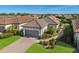Single-story home with gray garage door and landscaped yard at 8720 Bellussi Dr, Sarasota, FL 34238