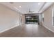 Spacious living room with tile floors and sliding doors to patio at 8720 Bellussi Dr, Sarasota, FL 34238
