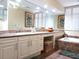 Elegant bathroom with double vanity, large mirror, and soaking tub at 1241 Gulf Of Mexico Dr # 708, Longboat Key, FL 34228