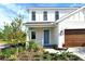 Two-story house with brown garage door and landscaped walkway at 2612 Star Apple Way, Sarasota, FL 34240