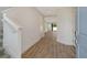 Light hallway with wood-look tile floors, leading to the living area at 2612 Star Apple Way, Sarasota, FL 34240