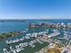 Aerial view of marina with boats, waterfront condos, and city skyline in the distance at 111 S Pineapple Ave # 613, Sarasota, FL 34236