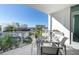 Balcony with comfortable seating and views of palm trees and the city skyline at 111 S Pineapple Ave # 613, Sarasota, FL 34236