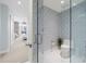 Modern bathroom featuring glass enclosed toilet with decorative wallpaper and marble floors at 111 S Pineapple Ave # 613, Sarasota, FL 34236