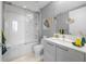 Bright bathroom with tiled shower/tub, modern vanity, and decorative accents at 111 S Pineapple Ave # 613, Sarasota, FL 34236