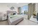 Serene bedroom featuring a plush bed, stylish decor, and a large window with a view of the pool area at 111 S Pineapple Ave # 613, Sarasota, FL 34236