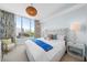 Serene bedroom with a tufted headboard, large windows, and colorful accents at 111 S Pineapple Ave # 613, Sarasota, FL 34236