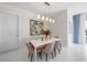 Elegant dining room with modern lighting, stylish art, and seating for six at 111 S Pineapple Ave # 613, Sarasota, FL 34236