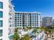 Exterior shot of a condo building featuring a pool, palm trees and high-rise architecture at 111 S Pineapple Ave # 613, Sarasota, FL 34236